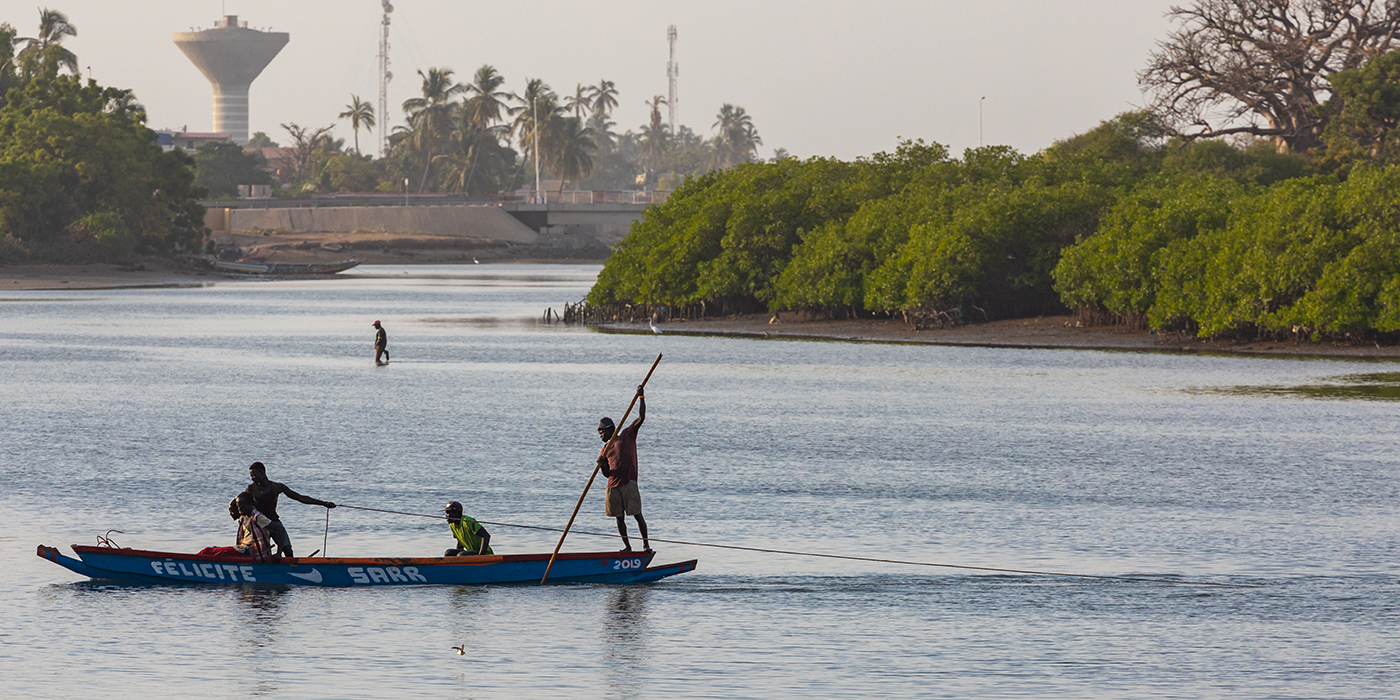 Fishers and small long boats. Fadiauth Island. Senegal. West Afr
