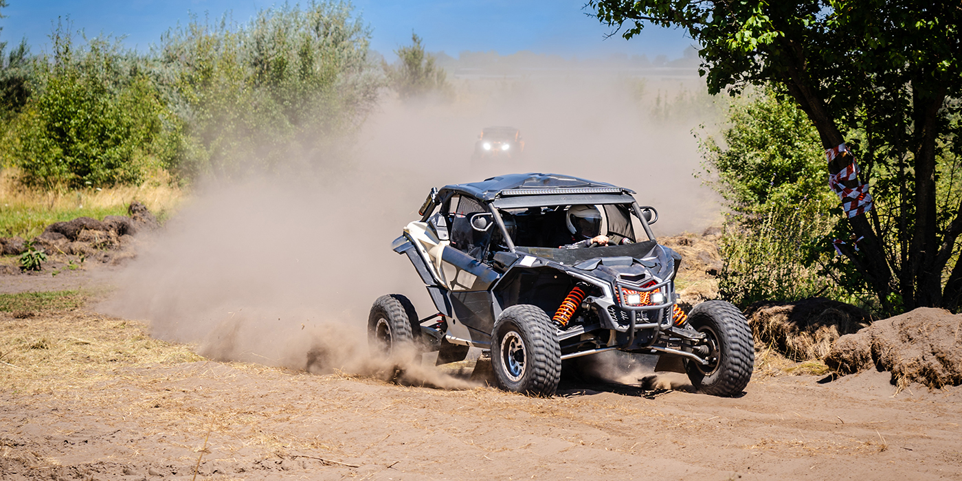 UTV buggy moves on dusty road. 4x4, extreme, adrenalin.